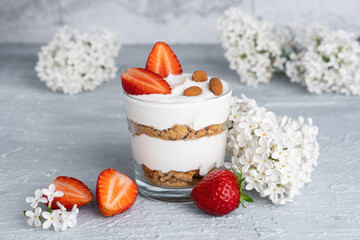 Ricotta dessert with fresh strawberries. Healthy breakfast of yogurt, strawberry and almonds