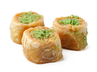Delicious baklava rolls with pistachio topping served on a neutral background