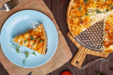 Fish tart. Piece of french pie with salmon and cheese. Quiche lauren with red fish cut off piece