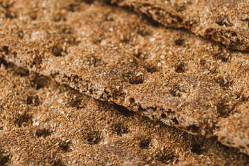 Crispy wheat, rye and corn flatbread crackers. Healthy food background. Extreme closeup