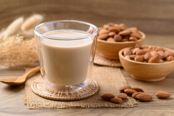 Almond milk in cup glass on wooden table, Alternative milk made from plant, non dairy