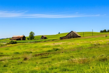 Obraz premium A serene country scene featuring rolling hills, rustic barns, and open fields under a wide clear blue sky.