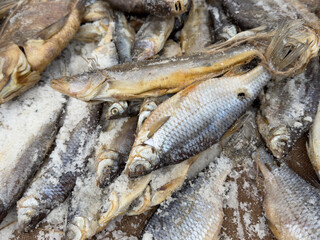 A pile of fish with salt on them