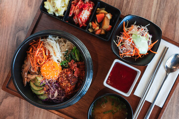 Korean bibimbap in a clay bowl with sides in Perth, Western Australia