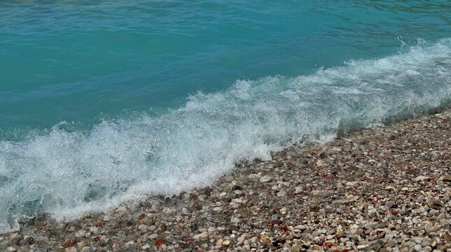 Sea wave on pebbles beach