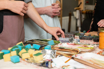 Art workshop scene with young caucasian adults engaging in creative activities