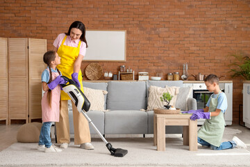 Cute little children helping their mother with cleaning routine at home