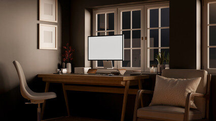 A cozy, minimalist home workspace at night featuring a computer on a wooden desk.