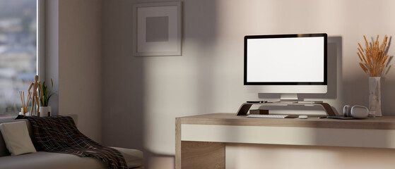 Comfortable, minimalist apartment living room featuring a computer desk, a sofa, and simple decor.