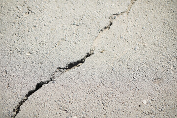 Close-Up of Asphalt with Large Crack Illustrating Structural Damage and Road Deterioration
