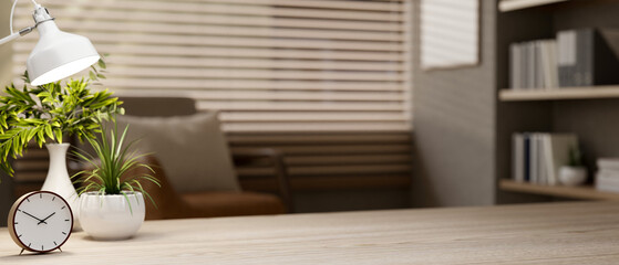 A close-up of a space on a wooden tabletop in a contemporary cozy room.