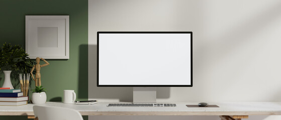 A front view of a computer with a white screen mockup on a table against the wall in a modern room.