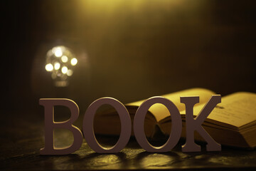 Open Book with 'BOOK' Letters in Warm, Cozy Light