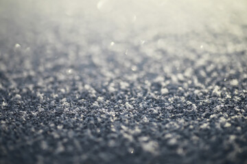 Close-Up of Frost-Covered Surface with Delicate Snowflakes in Soft Focus