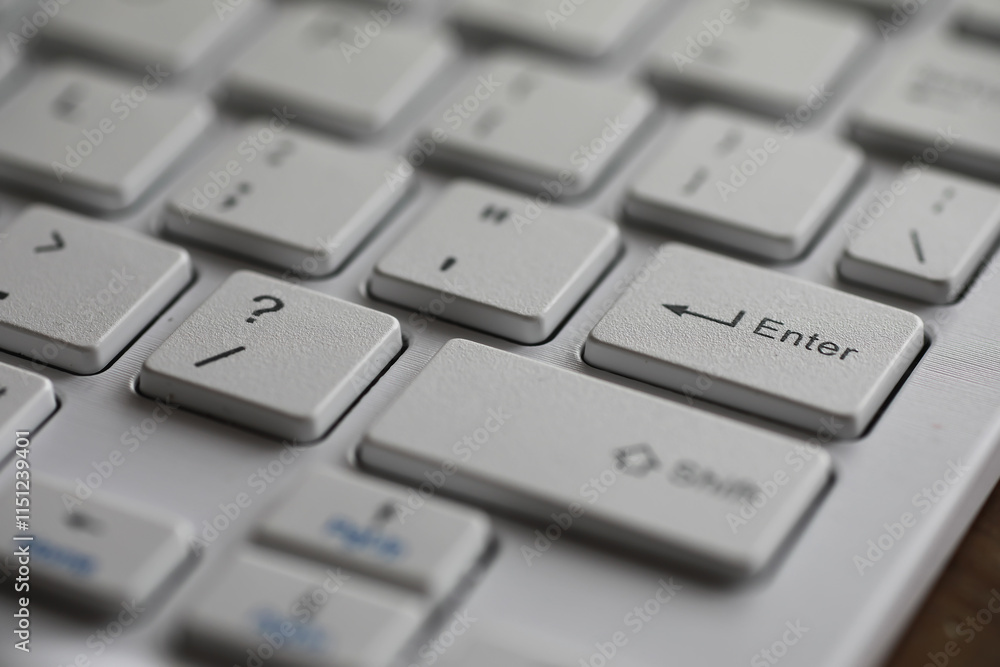 Aufkleber close-up of modern white keyboard with enter key highlighted