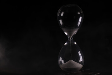 Minimalist White Sand Hourglass on Dark Background Emphasizing Time and Precision