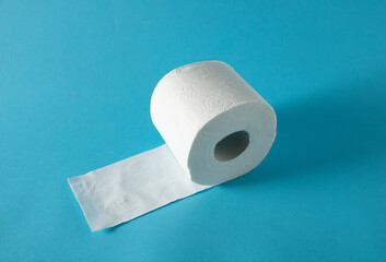 White organic toilet paper in the bathroom on blue tiles