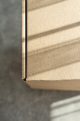 Close-up of kraft cardboard box with natural light and shadows