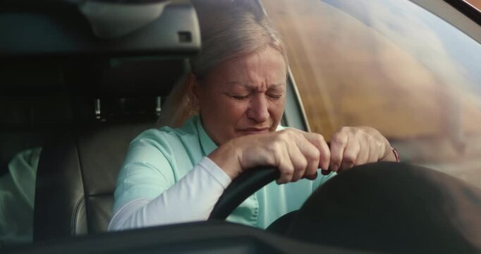 Nurse in her car at break with anxiety for patient loss grief feels stress and exhaustion, burnt out from work. Nurse with stress or depression in her car after death of patient