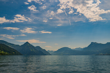 Mountain in the Alps in summer, panoramic view with mountain. Switzerland Alps nature and travel. Alpine scenery. Mountain with lake in Alps. Summer view over the lake and the alps in Switzerland.