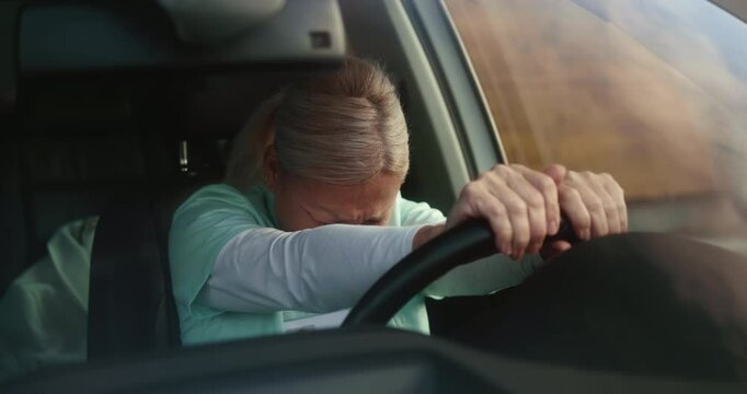 Nurse in her car at break with anxiety for patient loss grief feels stress and exhaustion, burnt out from work. Nurse with stress or depression in her car after death of patient