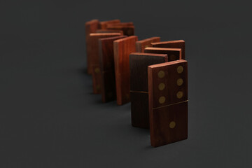 Wooden dominos blocks in shape of zigzag on black background