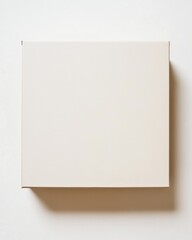 Minimalistic beige box casting a soft shadow on a clean white wall, perfect for packaging and branding concepts.