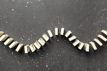 Many white dominos blocks on black background