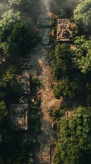 Aerial view of ancient ruins enveloped by lush greenery in a misty landscape.