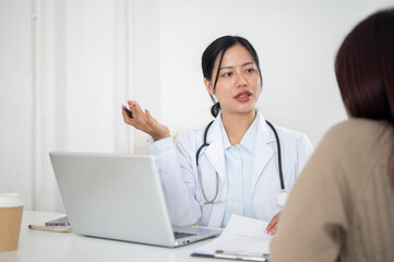 A doctor talking with a patient in the examination room, listening to the patient's symptoms.