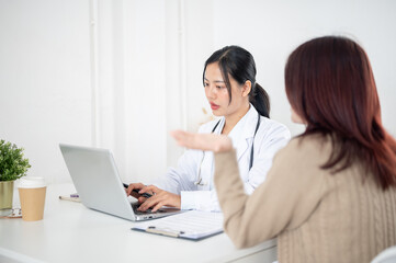 A doctor talking with a patient in the examination room, listening to the patient's symptoms.