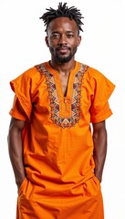 Fototapeta premium African man in traditional orange embroidered dashiki against white background