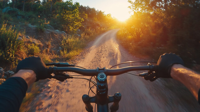 riding a mountainbike during summer in the road during sunrise with a eye-level angle 
