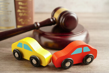 Car accident lawsuit and insurance, Judge hammer with car model.
