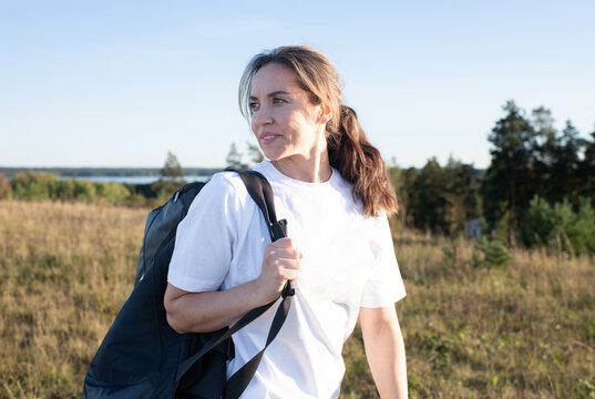 woman smiling after exercising outdoors in the sunshine