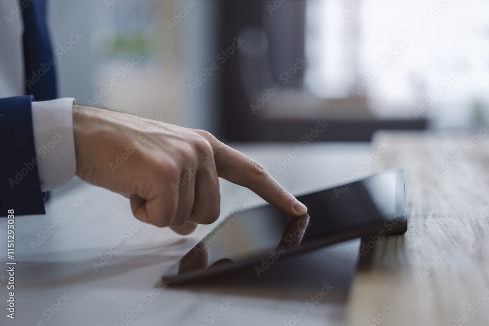 Poster Man's fingertip gently tapping the screen of a modern digital tablet lying on a desk, surrounded by the unfocused brightness of a contemporary office space