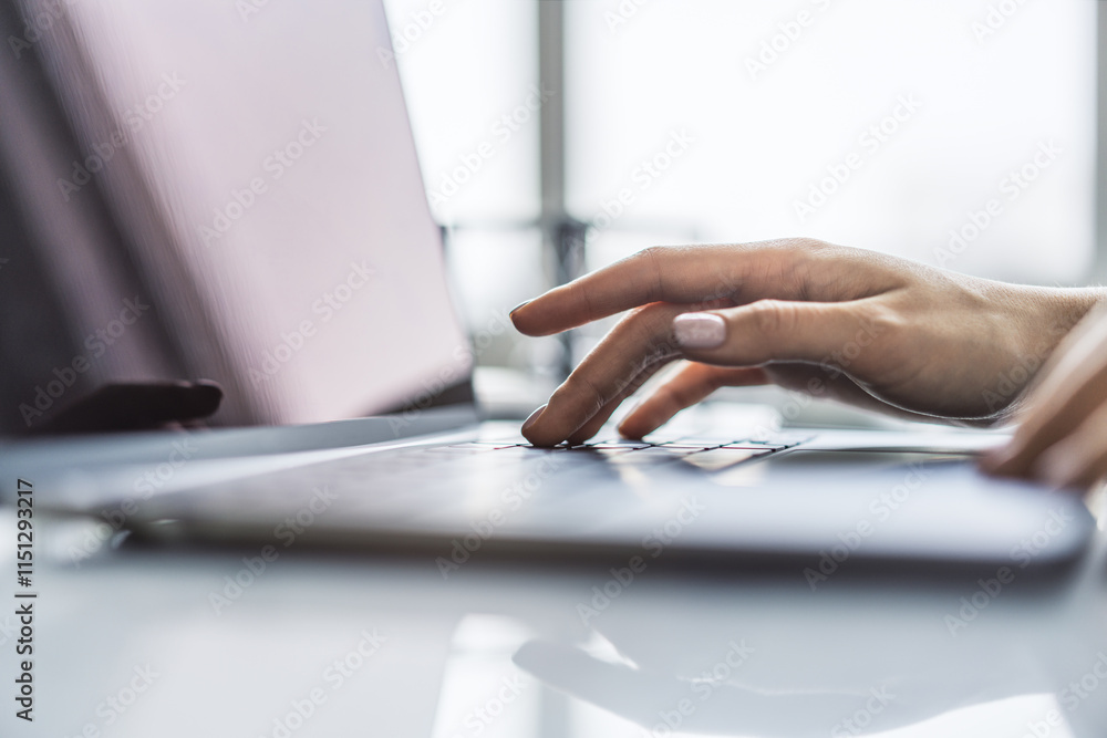 Poster a detailed view of female hands typing on a cutting-edge laptop keyboard, set against a hazy office 