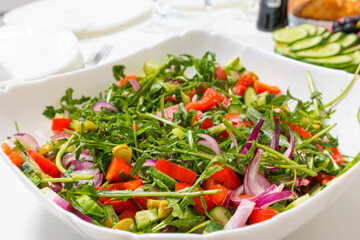 Traditional Vegetable Mix Salad in Round Plate Over White Surface On Table.