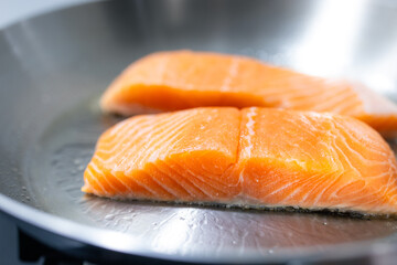 Fresh salmon fillets cooking on hot pan