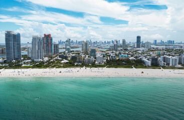 Naklejka premium Miami Beach scene from drone, Florida, USA. Miami seaside. Aerial view of Miami Beach and cityscape. Coastline of Miami Beach, aerial view. Famous American landmarks. Summer travel in USA.