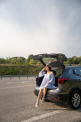 Woman Enjoying a Sunny Day by Her Car