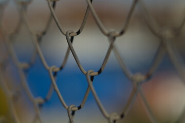 Rusty mesh fence close-up, selective focus