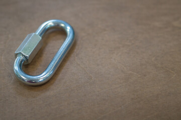 Climbing carabiner on a gray background close-up, selective focus