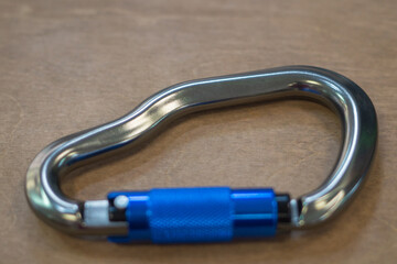 Climbing carabiner on a gray background close-up, selective focus