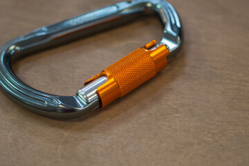 Climbing carabiner on a gray background close-up, selective focus