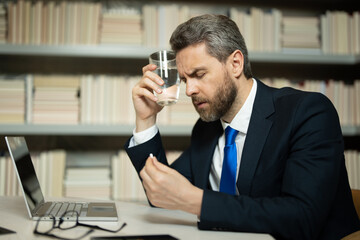 Business man got migraine touches her head because of pain. Man manager with strong headache...