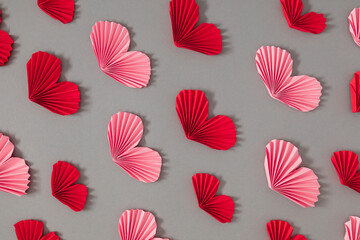 Pink and red paper hearts, valentines on gray background, hearts pattern. Mother's day, Valentine's day, love concept.