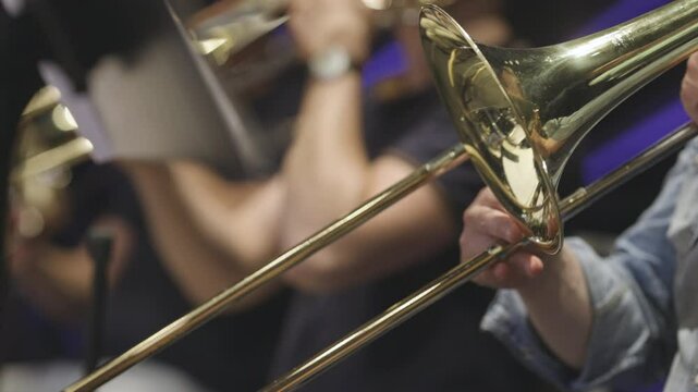A trombone player playing a section solo during a classical youth symphony orchestra rehearsal. Nr.1