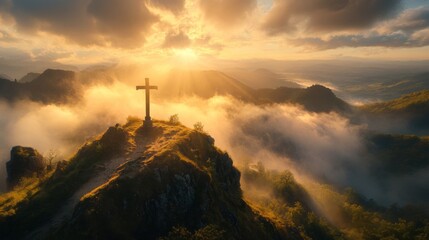 Fototapeta premium Majestic Cross Atop Misty Mountain Sunset
