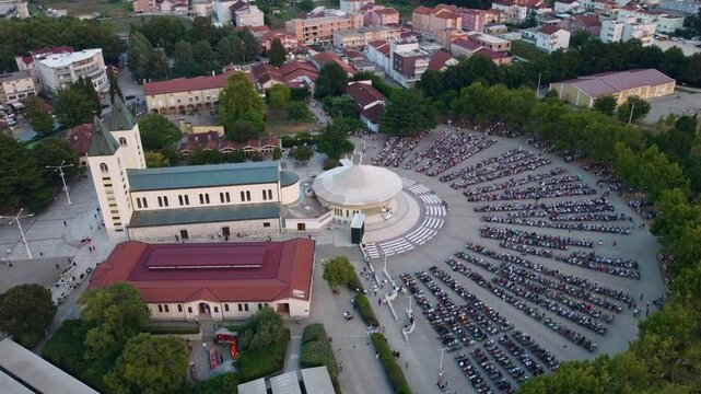 Crowd of people attending mass at the church in Medjugorje, Bosnia and Herzegovina. Tourist spot that attracts pilgrims in the summer to this place of prayer.
